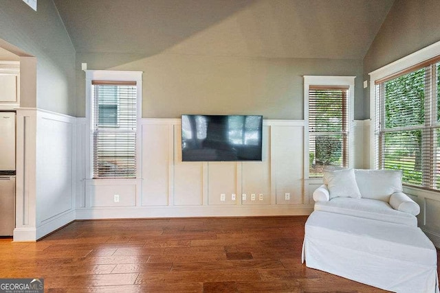 104 Beacon Crst, Newnan, GA 30265 - living room with vaulted ceiling, a decorative wall, hardwood / wood-style floors, wainscoting, and plenty of natural light