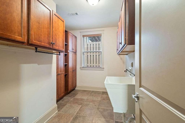 104 Beacon Crst, Newnan, GA 30265 - washroom featuring cabinet space and baseboards