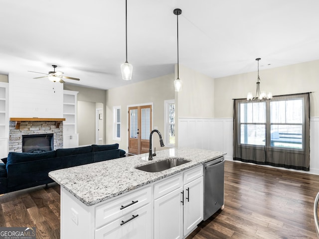 1847 Davis Mill Rd N, Dallas, GA 30157 - kitchen featuring dishwasher, a sink, ceiling fan, wainscoting, and a stone fireplace