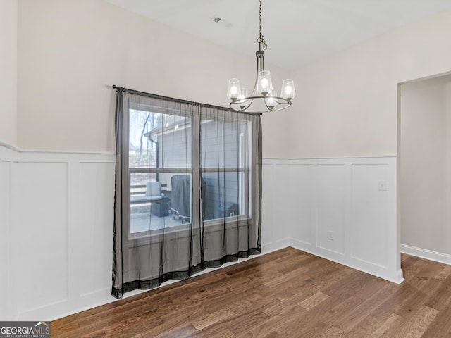 1847 Davis Mill Rd N, Dallas, GA 30157 - unfurnished dining area with a chandelier, a decorative wall, wainscoting, and wood finished floors