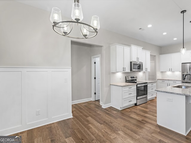 1847 Davis Mill Rd N, Dallas, GA 30157 - kitchen with stainless steel appliances, white cabinets, dark wood-type flooring, a sink, and light stone counters