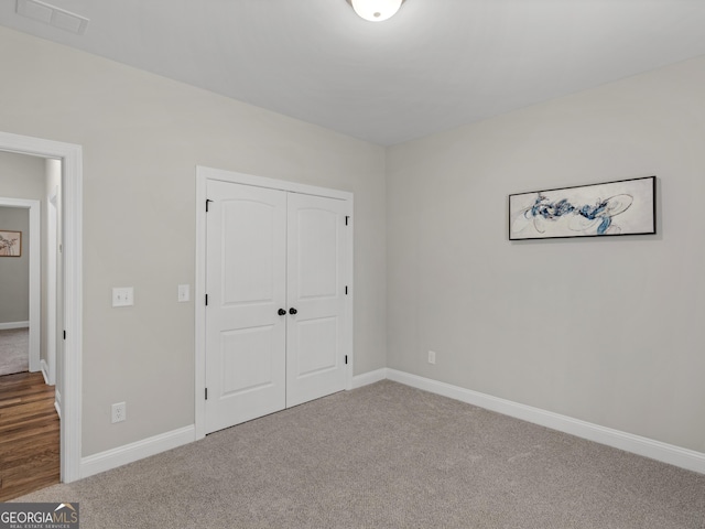 1847 Davis Mill Rd N, Dallas, GA 30157 - unfurnished bedroom featuring carpet flooring, a closet, and baseboards