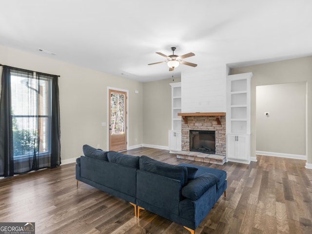 1847 Davis Mill Rd N, Dallas, GA 30157 - living area with dark wood-style floors, ceiling fan, baseboards, and a stone fireplace