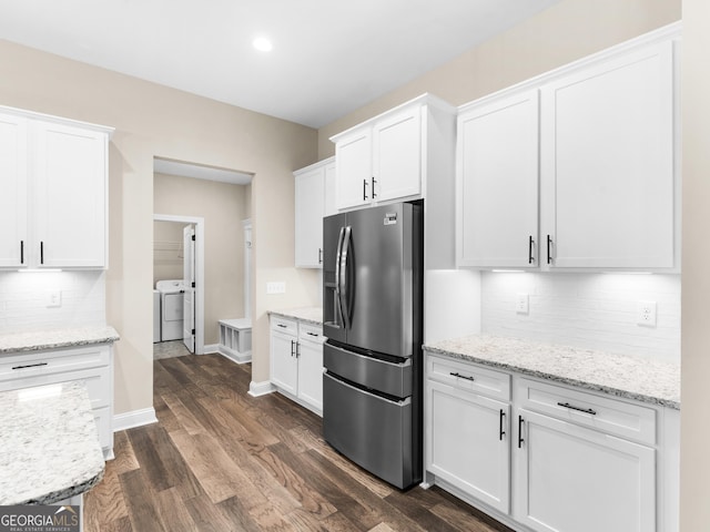1847 Davis Mill Rd N, Dallas, GA 30157 - kitchen featuring stainless steel fridge with ice dispenser, white cabinetry, tasteful backsplash, dark wood-style flooring, and washer and dryer