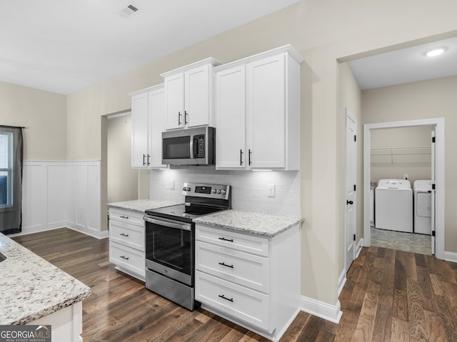 1847 Davis Mill Rd N, Dallas, GA 30157 - kitchen featuring appliances with stainless steel finishes, washer and dryer, light stone counters, white cabinets, and tasteful backsplash