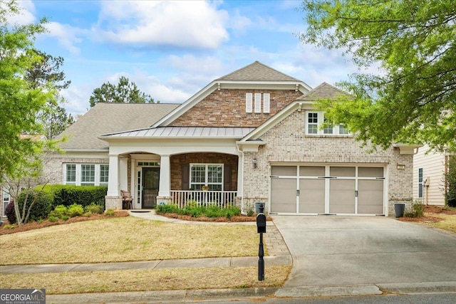 218 Begonia Ct, Griffin, GA 30223 - craftsman-style house featuring driveway, covered porch, a standing seam roof, brick siding, and a front yard