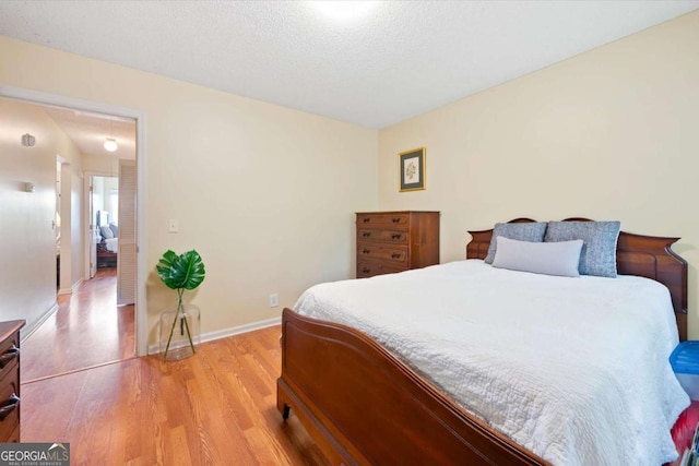 226 Bull River Bluff Dr, Savannah, GA 31410 - bedroom featuring light wood finished floors, baseboards, and a textured ceiling