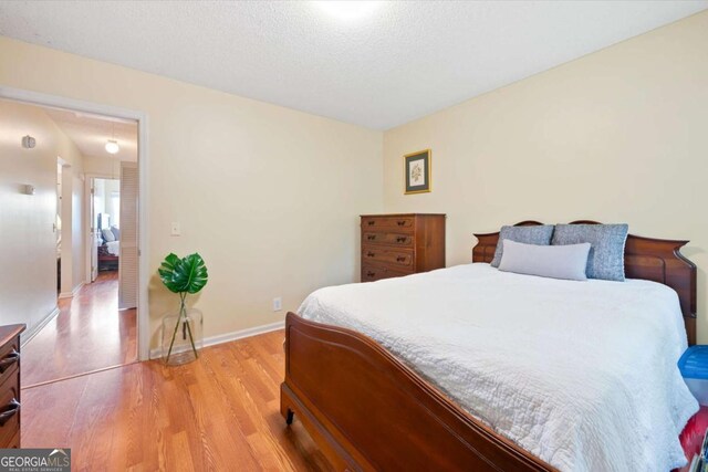 226 Bull River Bluff Dr, Savannah, GA 31410 - bedroom featuring light wood finished floors and a textured ceiling