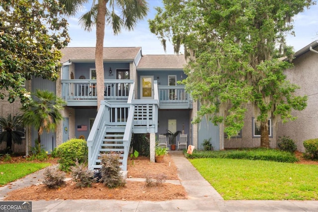 226 Bull River Bluff Dr, Savannah, GA 31410 - view of front of home with a front yard, stairs, and roof with shingles