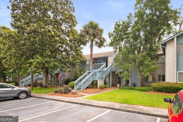 226 Bull River Bluff Dr, Savannah, GA 31410 - view of building exterior with stairway and uncovered parking