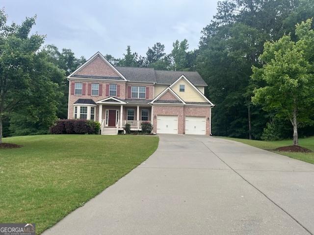 82 Sweetwater Way, Senoia, GA 30276 - view of front facade with driveway, a front lawn, and brick siding