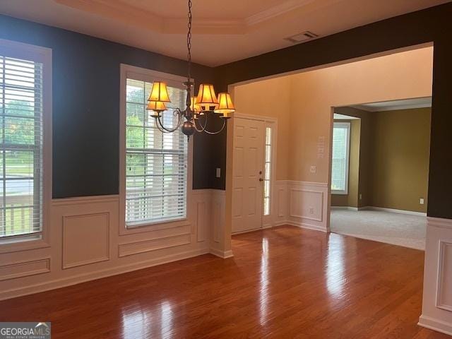 82 Sweetwater Way, Senoia, GA 30276 - entryway with a raised ceiling, a chandelier, wainscoting, plenty of natural light, and wood finished floors