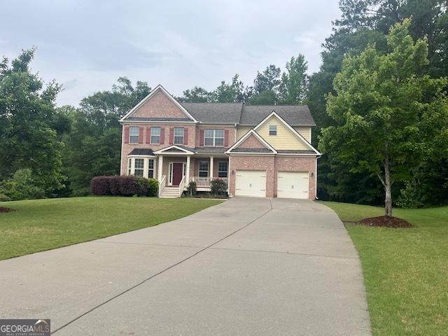 82 Sweetwater Way, Senoia, GA 30276 - view of front of home featuring driveway, a front lawn, and brick siding