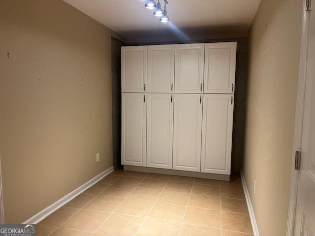 82 Sweetwater Way, Senoia, GA 30276 - unfurnished bedroom with light tile patterned flooring and baseboards