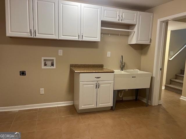 82 Sweetwater Way, Senoia, GA 30276 - washroom with hookup for a washing machine, light tile patterned floors, baseboards, and cabinet space