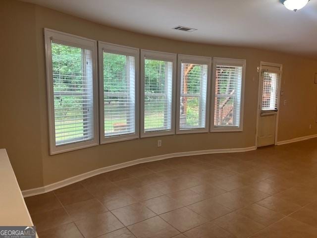 82 Sweetwater Way, Senoia, GA 30276 - empty room with plenty of natural light, baseboards, and dark tile patterned floors