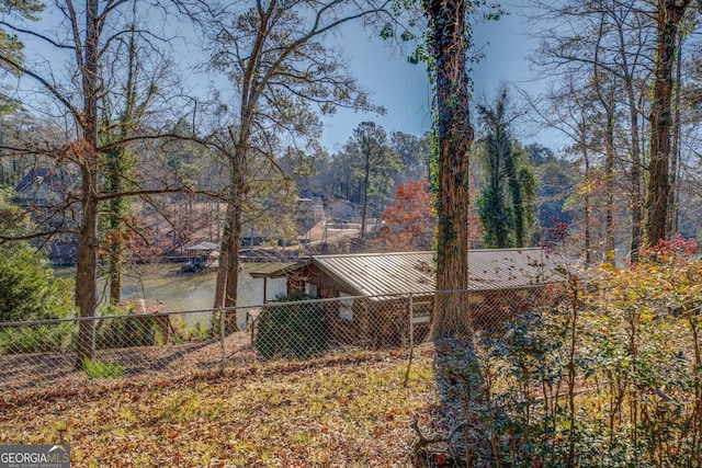 126 Shannon Way, Jackson, GA 30233 - view of property exterior featuring a fenced backyard, a standing seam roof, and a metal roof