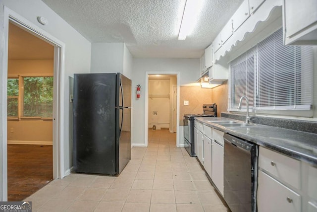 2046 Rector Dr SW, Atlanta, GA 30311 - kitchen with freestanding refrigerator, dishwasher, stainless steel range oven, a textured ceiling, and white cabinetry