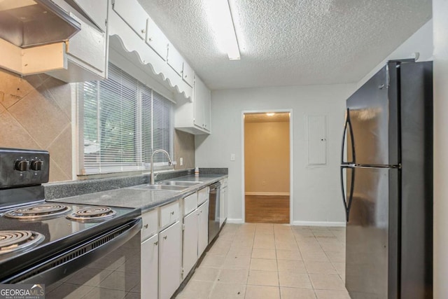 2046 Rector Dr SW, Atlanta, GA 30311 - kitchen featuring freestanding refrigerator, black electric range oven, a textured ceiling, white cabinets, and dishwasher