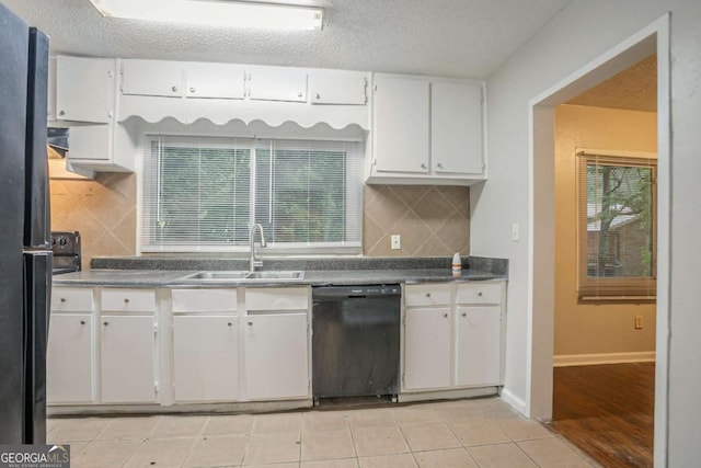 2046 Rector Dr SW, Atlanta, GA 30311 - kitchen with black appliances, white cabinets, decorative backsplash, light tile patterned flooring, and dark countertops