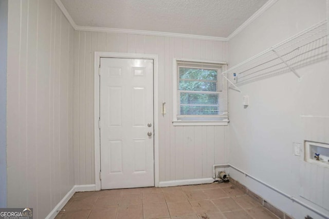 2046 Rector Dr SW, Atlanta, GA 30311 - laundry room featuring crown molding, wooden walls, hookup for a washing machine, light tile patterned floors, and a textured ceiling