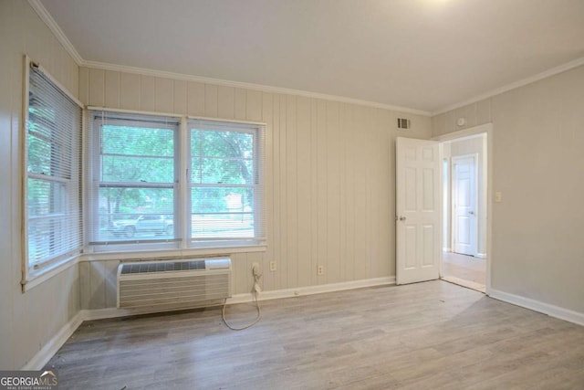 2046 Rector Dr SW, Atlanta, GA 30311 - empty room featuring wood finished floors, crown molding, a wall mounted air conditioner, and plenty of natural light