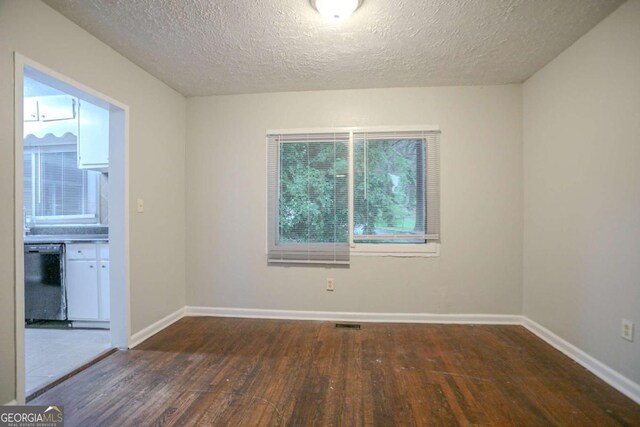 2046 Rector Dr SW, Atlanta, GA 30311 - empty room with wood finished floors and a textured ceiling