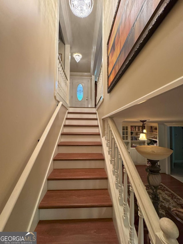 334 Eagle Cir, Dillard, GA 30537 - stairway featuring a towering ceiling, wood finished floors, a chandelier, and crown molding