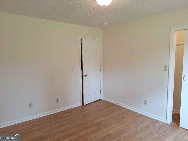 1261 Glenn Carrie Rd, Hull, GA 30646 - unfurnished room with wood finished floors, baseboards, and a textured ceiling