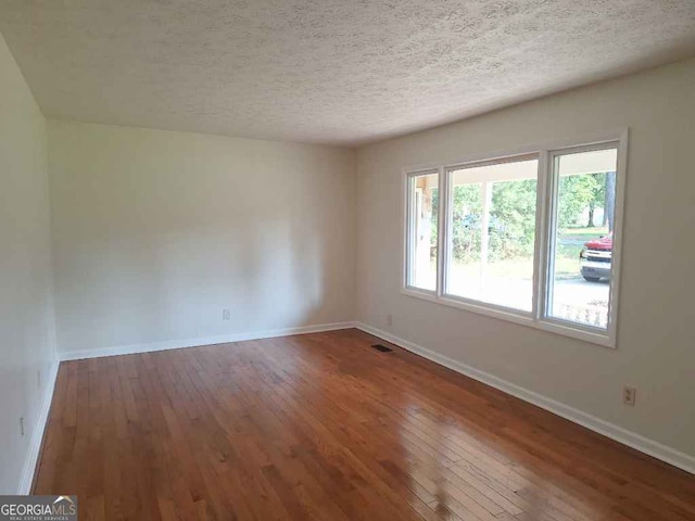 1261 Glenn Carrie Rd, Hull, GA 30646 - empty room featuring wood-type flooring, baseboards, and a textured ceiling