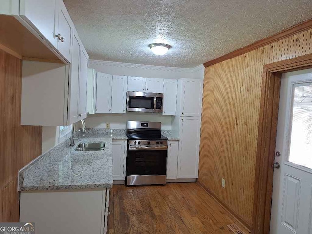 1261 Glenn Carrie Rd, Hull, GA 30646 - kitchen with stainless steel appliances, a sink, ornamental molding, white cabinets, and a textured ceiling