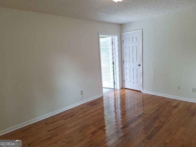 1261 Glenn Carrie Rd, Hull, GA 30646 - unfurnished room featuring wood finished floors, a textured ceiling, and baseboards