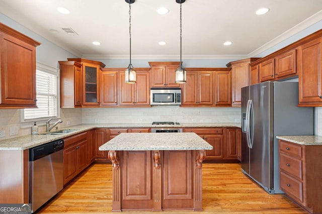 4503 Kendall Way, Roswell, GA 30075 - kitchen with appliances with stainless steel finishes, a sink, ornamental molding, a kitchen island, and light wood-type flooring