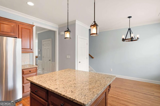 4503 Kendall Way, Roswell, GA 30075 - kitchen with freestanding refrigerator, a kitchen island, light wood-style floors, a chandelier, and hanging light fixtures