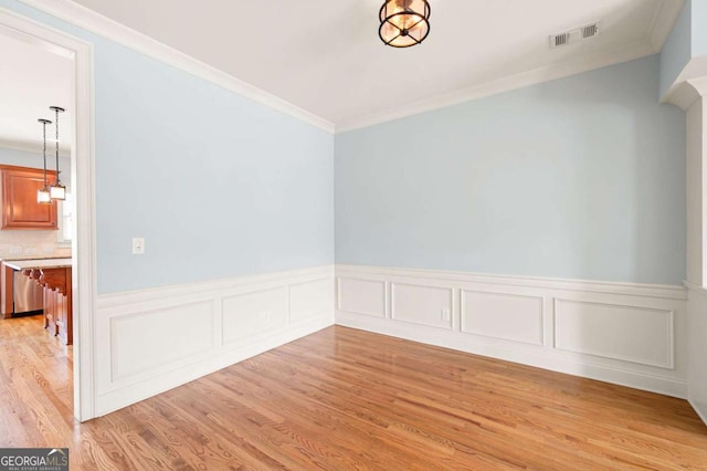 4503 Kendall Way, Roswell, GA 30075 - spare room with crown molding, a wainscoted wall, and light wood finished floors