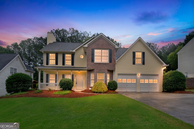 4009 Riverstone Dr, Suwanee, GA 30024 - view of front of home with a garage, driveway, a chimney, a lawn, and brick siding