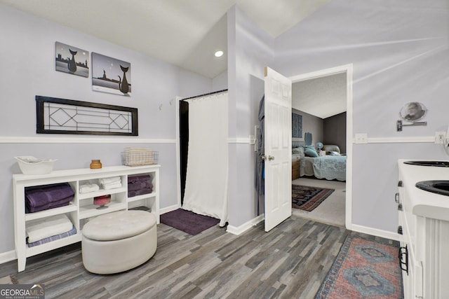 404 Carruth Rd, Winder, GA 30680 - full bath with vaulted ceiling, ensuite bath, wood finished floors, curtained shower, and vanity