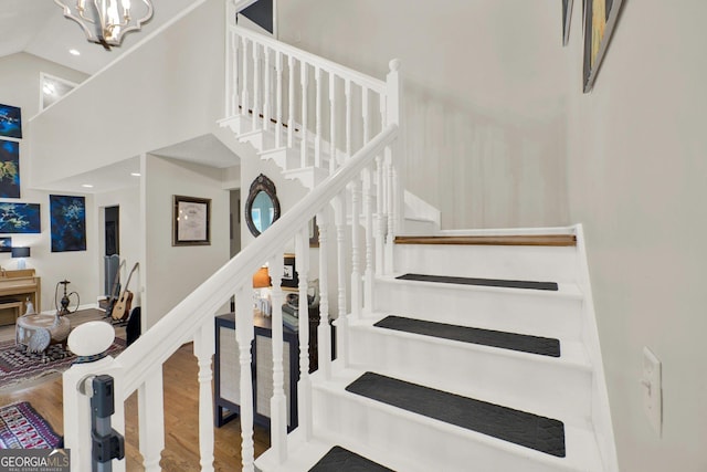 404 Carruth Rd, Winder, GA 30680 - stairway with a high ceiling, wood finished floors, and a chandelier