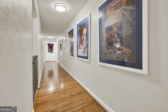 404 Carruth Rd, Winder, GA 30680 - corridor with wood finished floors, baseboards, a textured ceiling, and a textured wall