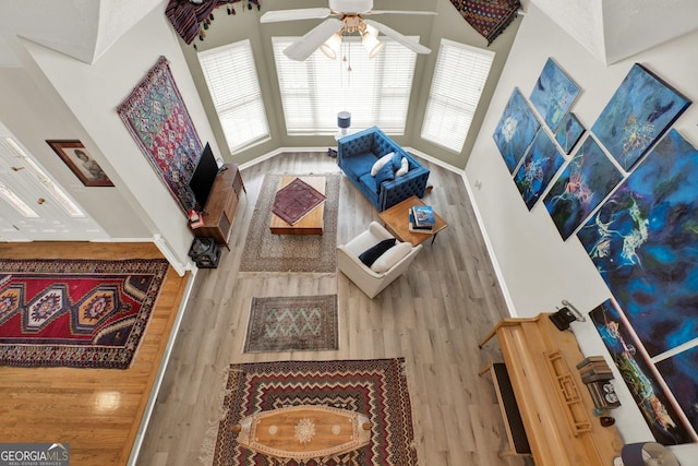 404 Carruth Rd, Winder, GA 30680 - living room featuring wood finished floors, a ceiling fan, and a high ceiling