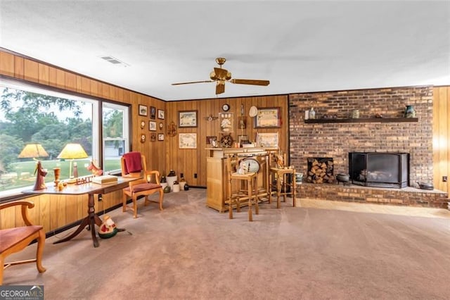 190 Roberts Way, Cornelia, GA 30531 - living area featuring carpet flooring, wooden walls, a ceiling fan, and a brick fireplace