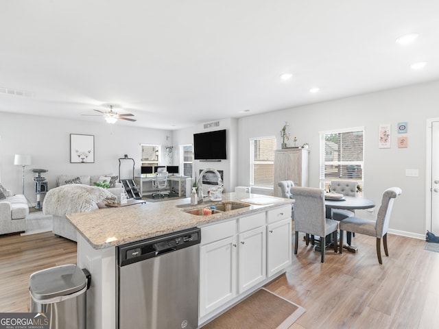 445 Sawmill Trce, Hampton, GA 30228 - kitchen featuring stainless steel dishwasher, a sink, open floor plan, white cabinets, and an island with sink
