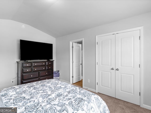 445 Sawmill Trce, Hampton, GA 30228 - bedroom with carpet floors, vaulted ceiling, a closet, and baseboards