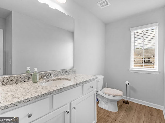 445 Sawmill Trce, Hampton, GA 30228 - bathroom featuring wood finished floors, vanity, toilet, and baseboards