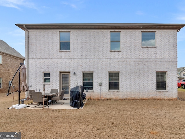 445 Sawmill Trce, Hampton, GA 30228 - back of house with a patio, brick siding, and a yard