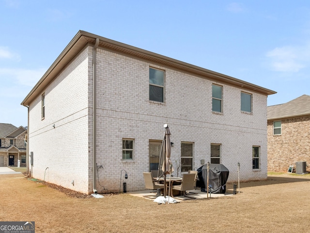 445 Sawmill Trce, Hampton, GA 30228 - back of house with cooling unit, a patio, and brick siding