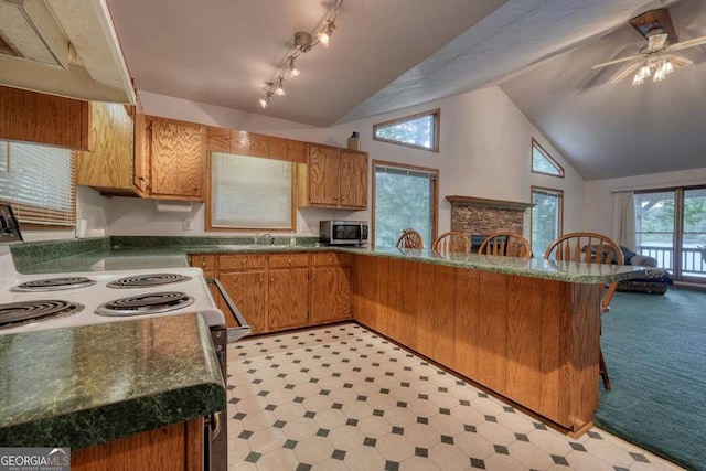 2309 Ridgecrest Cir, Hiawassee, GA 30546 - kitchen with stainless steel microwave, white range with electric stovetop, a peninsula, light flooring, and a ceiling fan
