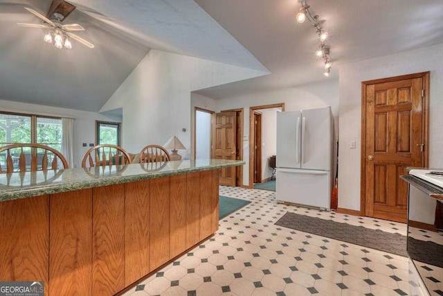 2309 Ridgecrest Cir, Hiawassee, GA 30546 - kitchen featuring white appliances, light floors, and brown cabinets