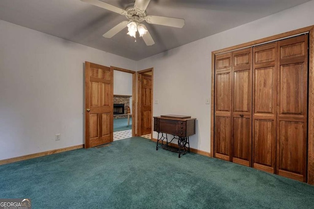 2309 Ridgecrest Cir, Hiawassee, GA 30546 - bedroom featuring a fireplace, carpet, baseboards, ceiling fan, and a closet