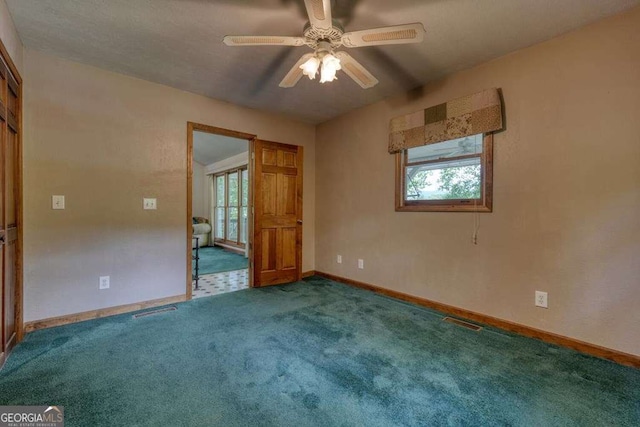 2309 Ridgecrest Cir, Hiawassee, GA 30546 - unfurnished bedroom with multiple windows, carpet, baseboards, and ceiling fan